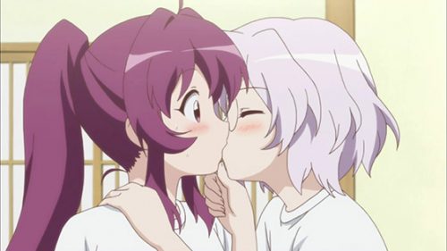 2 anime girl kissing on a bed 