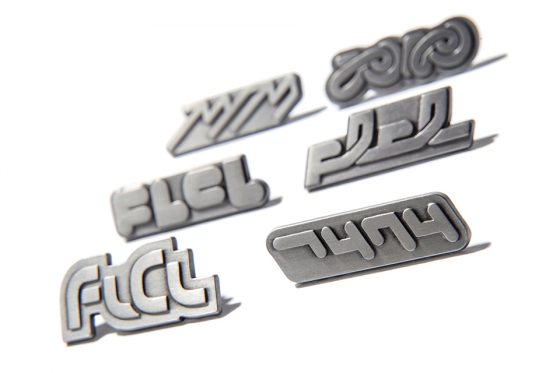 FLCL-Writing-560x315 Pin Badges of All Six FLCL OVA Title Logos! Pre-orders for the FLCL Logo Pin Badge Set Have Begun!